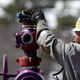 A worker switches well heads during a pause in the water pumping phase at the site of a hydraulic fracturing operation in Colorado. (Image: AP)